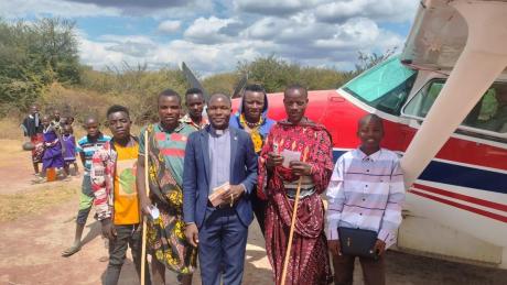 Group gathers in front of plane