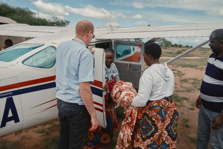 A jovial Neema returns to Malambo with her newborn baby. ~ Photo credit: Justin Maclean