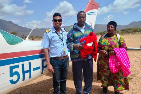 Pilot Roshan with the patient and his wife