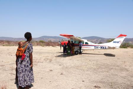 Woman looking at MAF plane in Mahaka