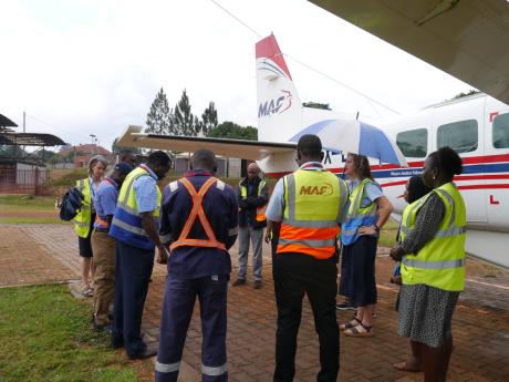 MAF Uganda staff says a prayer of thanksgiving before departure to Tanzania.
