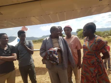 Israel getting escorted to the medevac plane